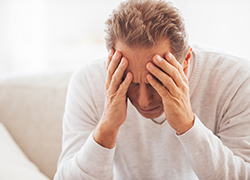 man holding head depressed