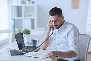 man on phone portraying calling mental health hotline